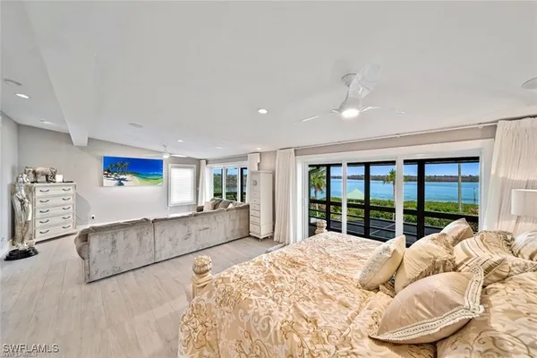 a bed sitting in a bedroom next to a large window