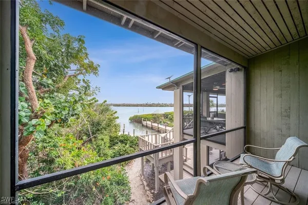 a view of a chair and table in the balcony