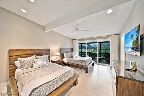 a bedroom with double bed and a large window