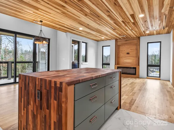 a spacious bedroom with a large bed and large windows