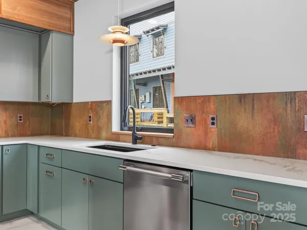 a kitchen with a sink cabinets and a window