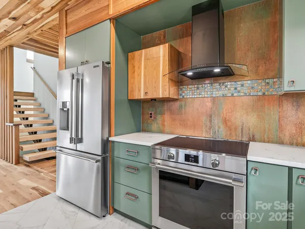 a kitchen with appliances cabinets and a window