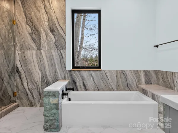 a bathroom with a bathtub and shower
