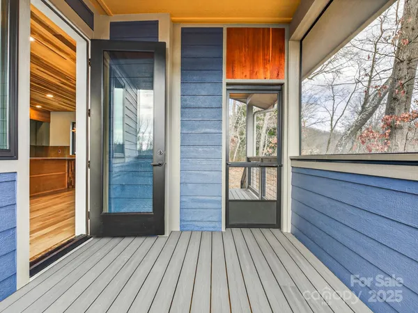 a view of outdoor space with wooden floor and windows