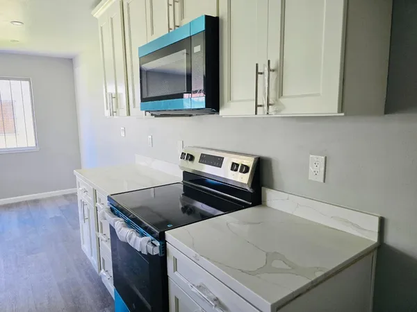 a kitchen with a stove and a microwave