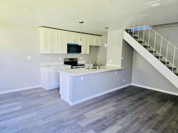 a kitchen with sink cabinets and microwave