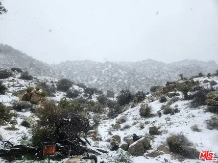 a view of a large building with mountains in the background