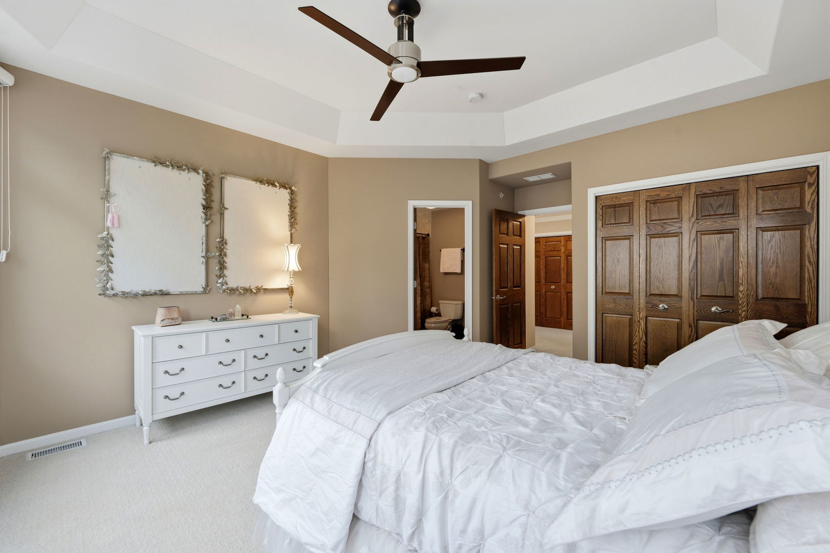 1406 Rue Paris Place Inverness, IL 60067 - Photo 20 of 35 a bedroom with a bed a dresser and a chandelier