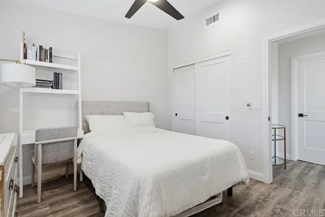 a bedroom with a bed and a desk