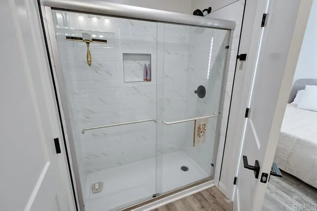 a bathroom with a glass door shower