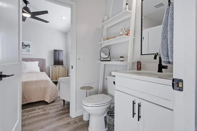 a bathroom with a sink a toilet and a mirror