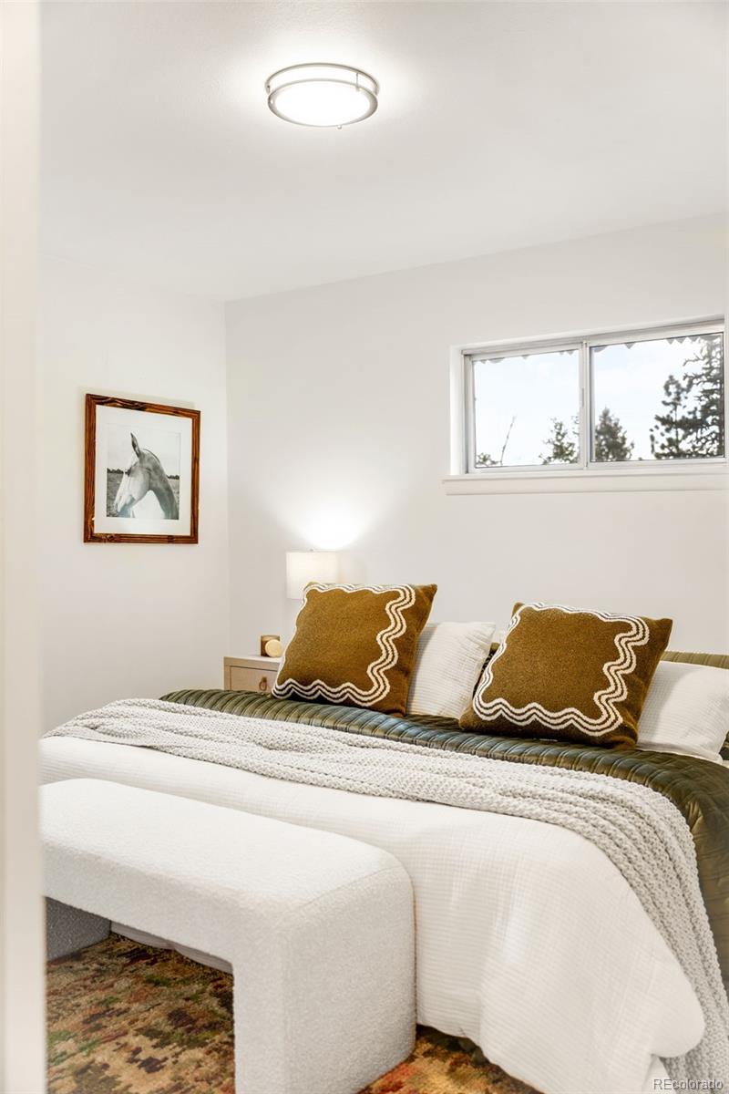 34657 Mohawk Trail Pine, CO 80470 - Photo 18 of 46 a bedroom with two bed and painting on the wall