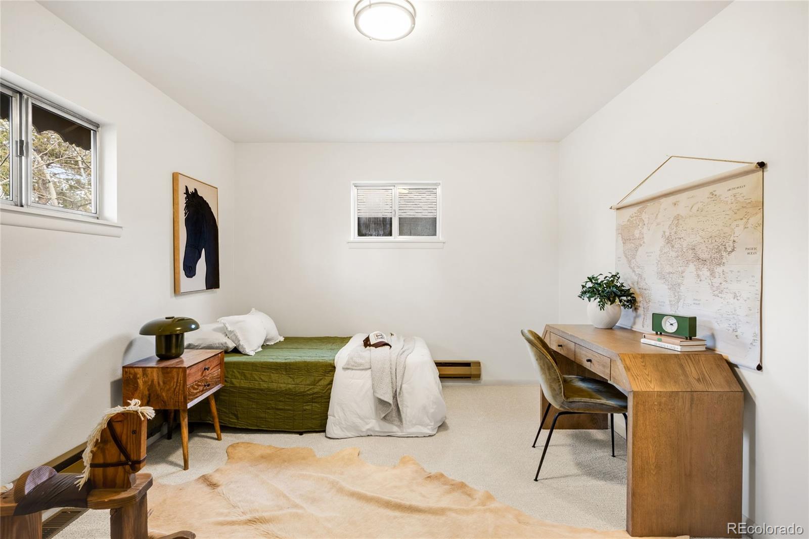 34657 Mohawk Trail Pine, CO 80470 - Photo 26 of 46 a bedroom with a bed and a table in it
