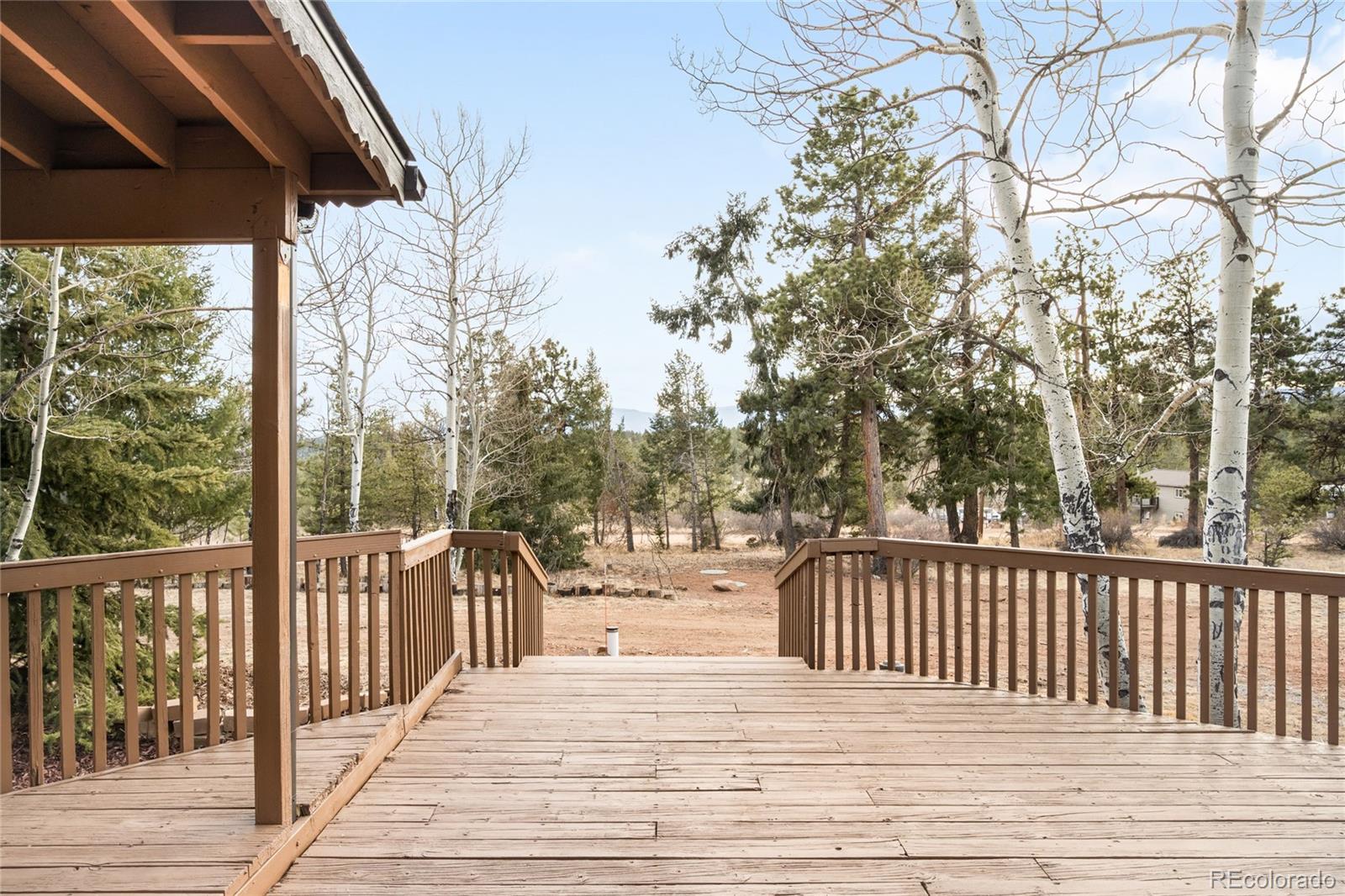 34657 Mohawk Trail Pine, CO 80470 - Photo 30 of 46 a view of a balcony with wooden floor and fence