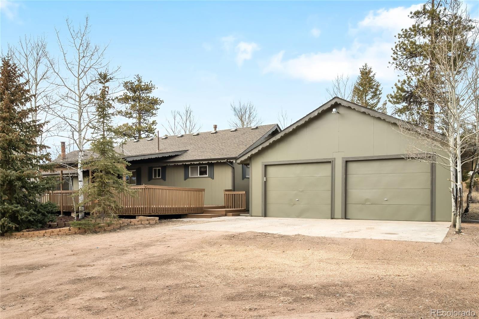 34657 Mohawk Trail Pine, CO 80470 - Photo 35 of 46 a front view of a house with a yard and garage