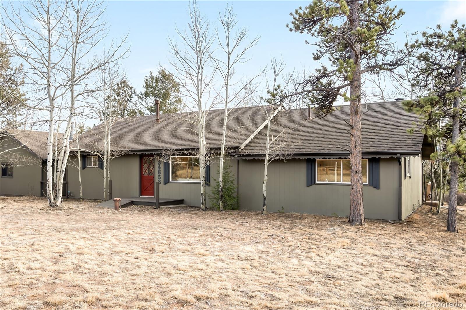 34657 Mohawk Trail Pine, CO 80470 - Photo 39 of 46 a backyard of a house with large tree and wooden fence