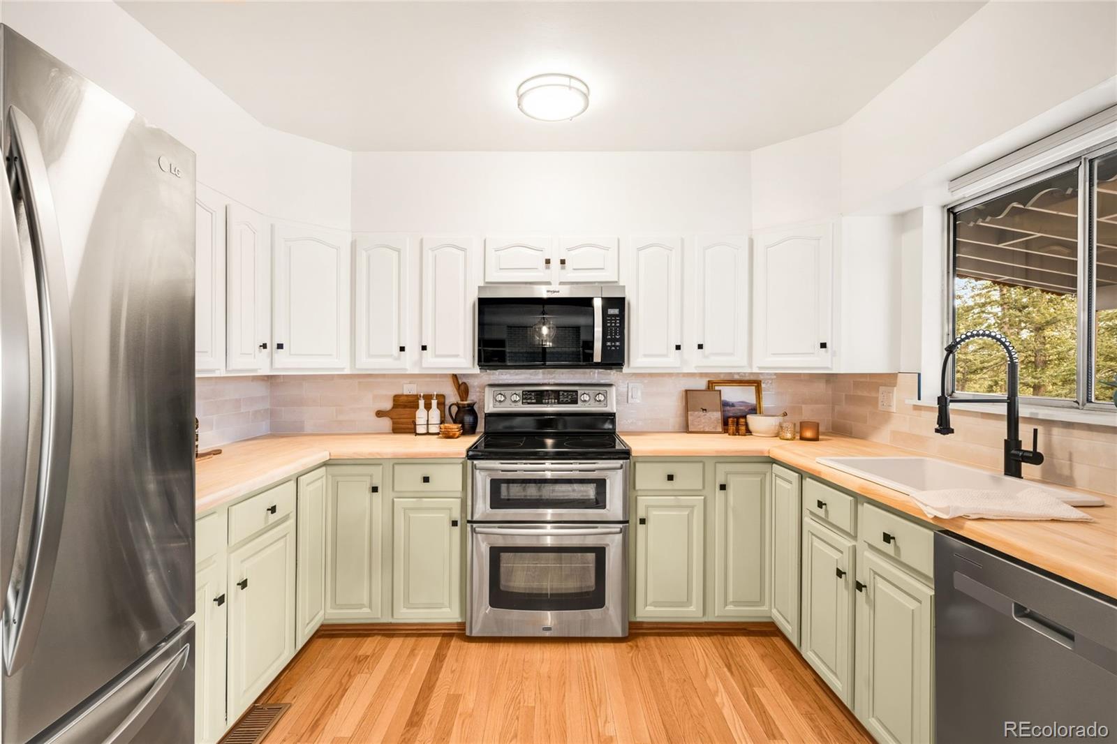 34657 Mohawk Trail Pine, CO 80470 - Photo 7 of 46 a kitchen with a sink stove and white cabinets