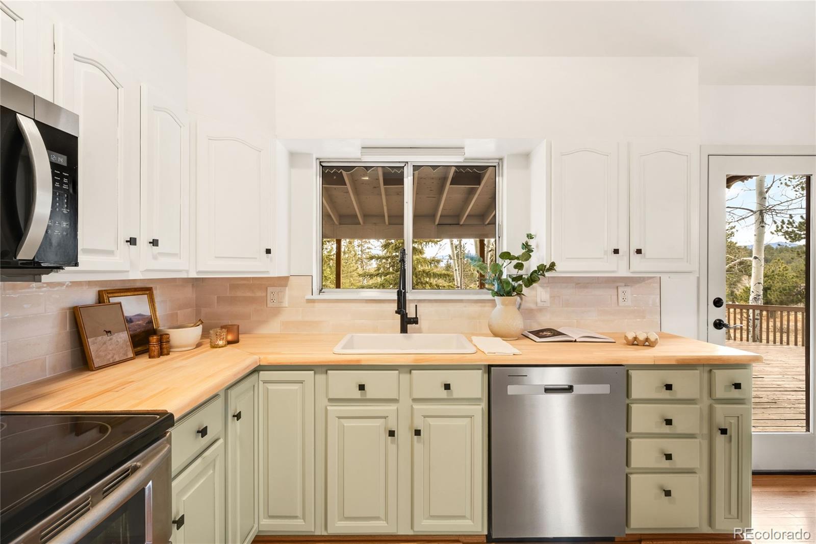 34657 Mohawk Trail Pine, CO 80470 - Photo 9 of 46 a kitchen with granite countertop a sink a stove and cabinets