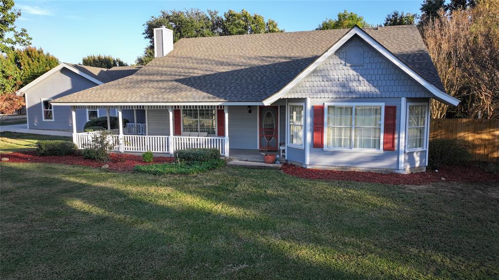 1364 Winn Road Bowie, TX 76230 - Photo 1 of 38 a front view of a house with a yard and garage