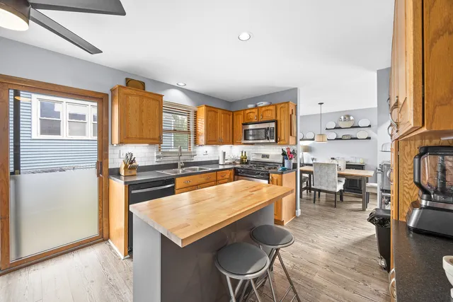 a large kitchen with a table and chairs in it