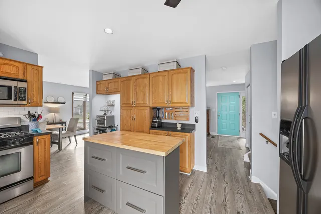 a kitchen with granite countertop a refrigerator stove and sink