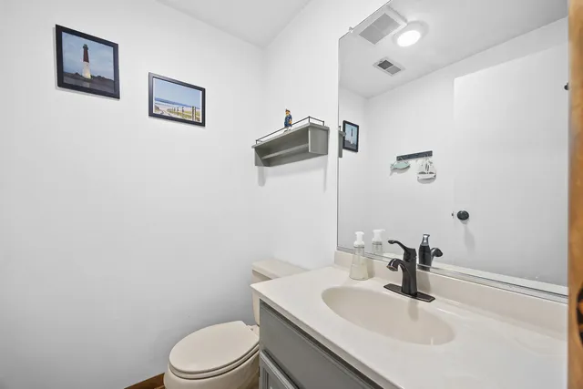 a bathroom with a sink toilet and vanity