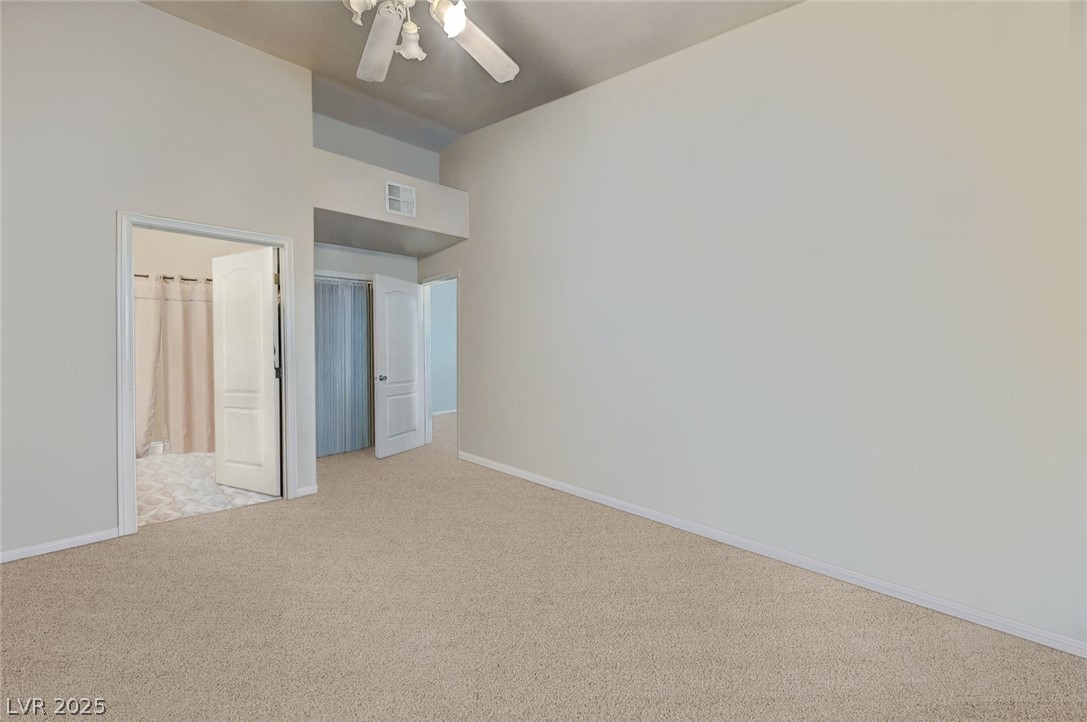 2305 West Horizon Ridge Parkway, Unit 1223 Henderson, NV 89052 - Photo 18 of 28 Unfurnished bedroom featuring light colored carpet and ceiling fan
