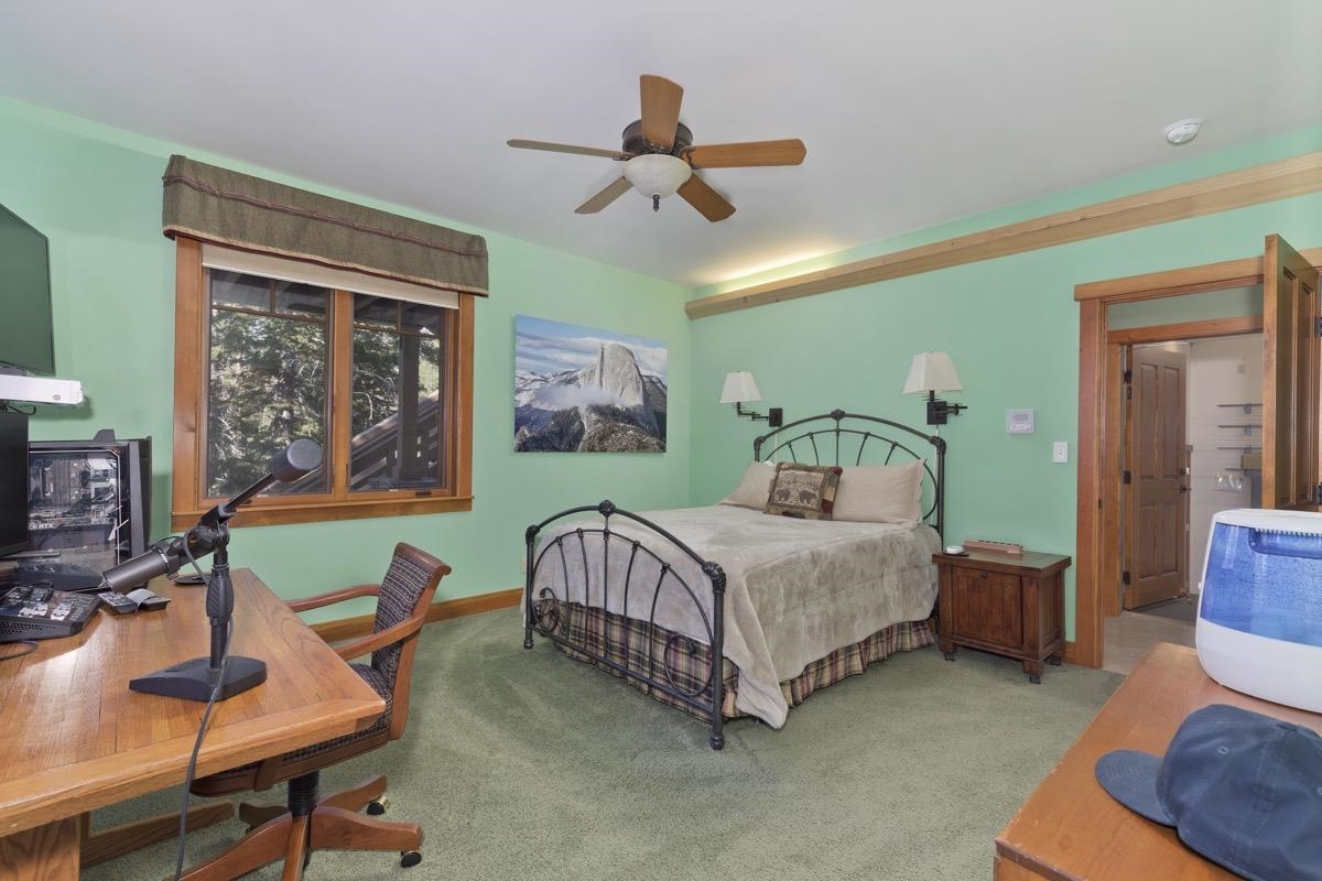 2500 Old Mammoth Road Mammoth Lakes, CA 93546 - Photo 39 of 48 a bedroom with a bed a chair and a chandelier