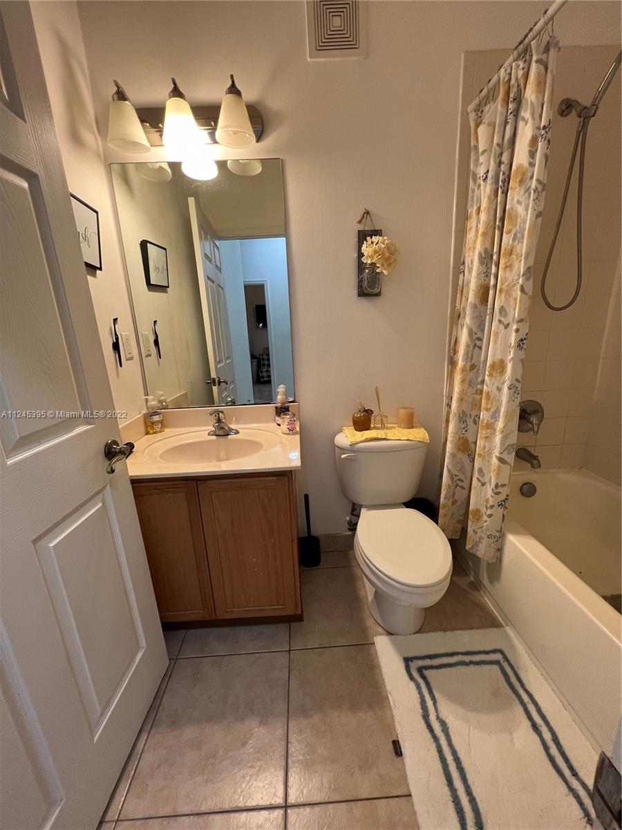 Hampton Hills Condominiums Tamarac, FL 33321 - Photo 12 of 24 a bathroom with a sink a toilet and shower