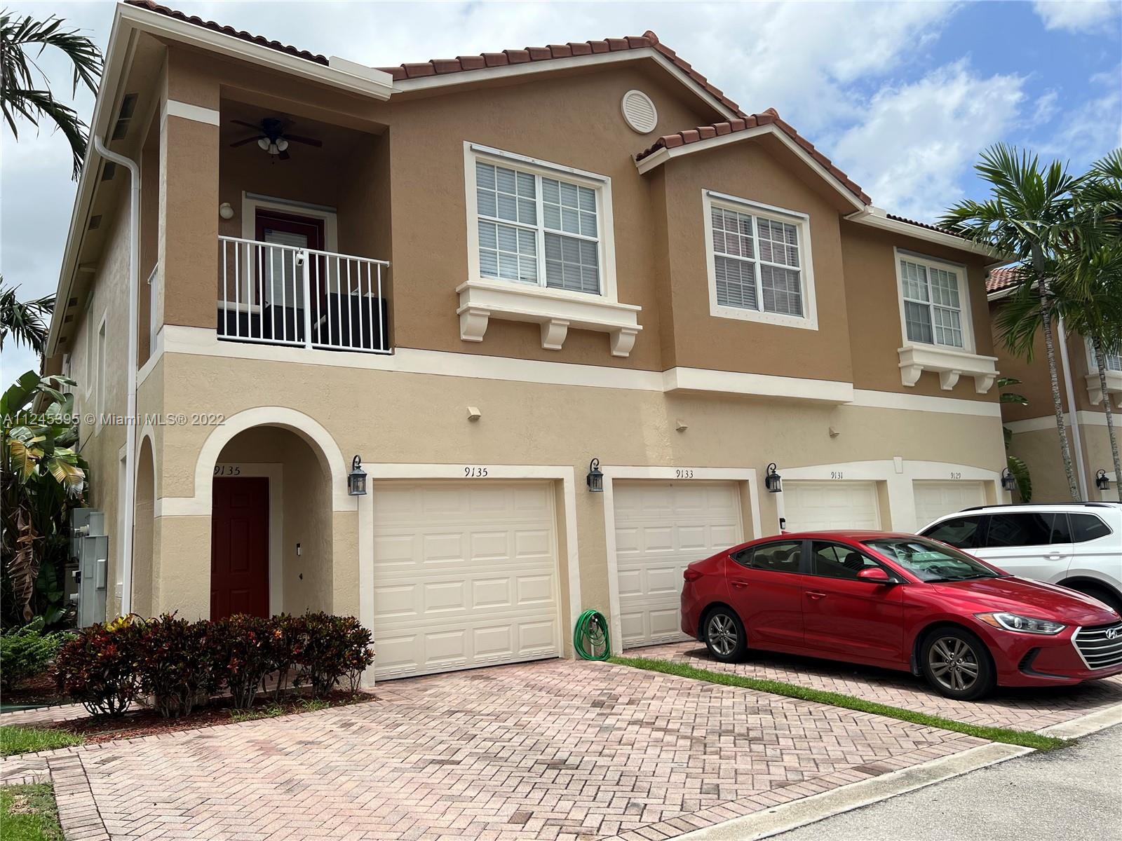 Hampton Hills Condominiums Tamarac, FL 33321 - Photo 16 of 24 a front view of a house with a garden