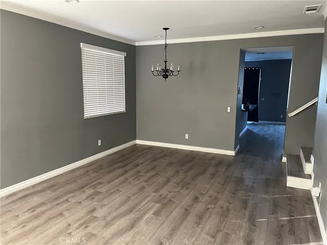 an empty room with windows and entrance