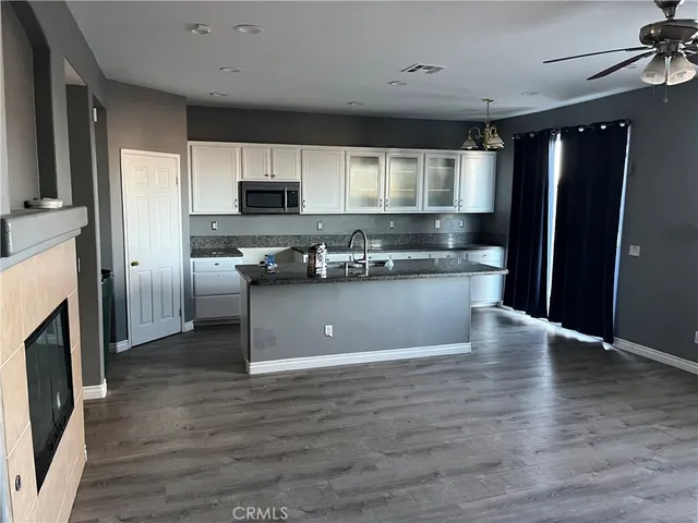 a kitchen with stainless steel appliances granite countertop a refrigerator a sink a stove and oven