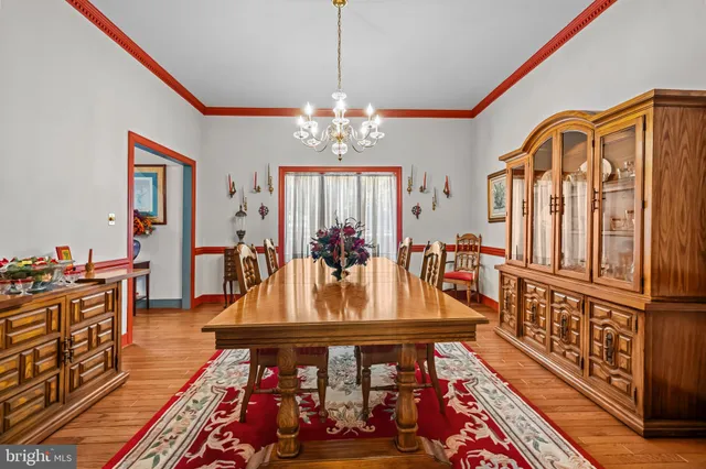 a view of a dining room with furniture and a chandelier