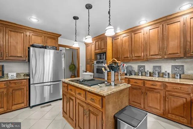 a living room with furniture chandelier and a flat screen tv