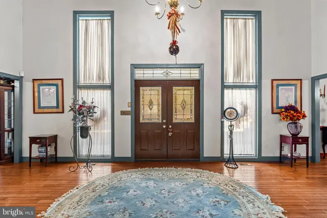 a view of entryway and hall with wooden floor