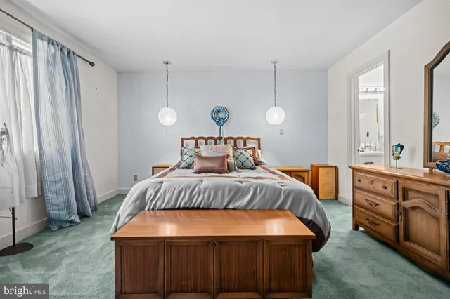 a patio with table and chairs and potted plants