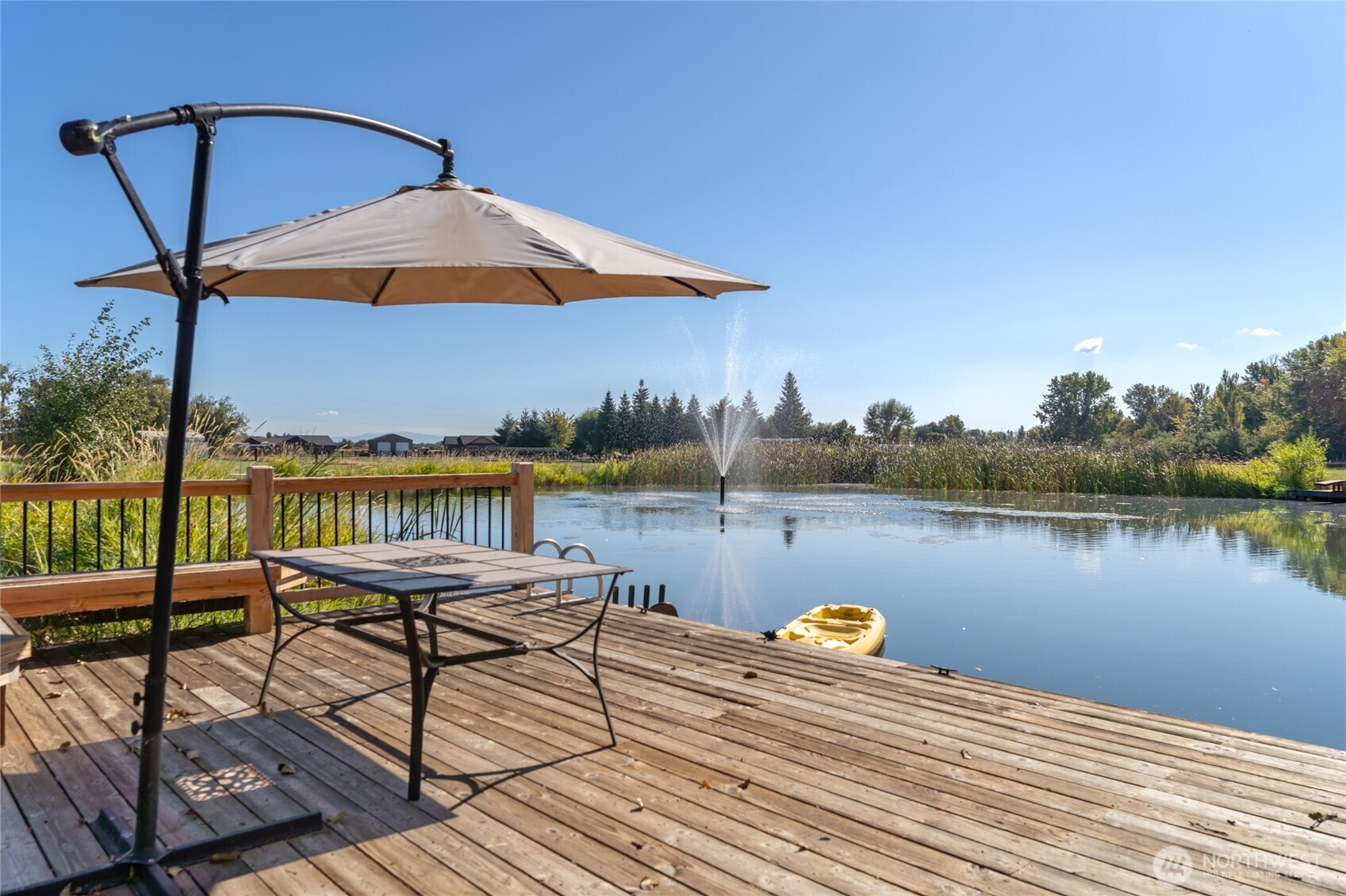 471 Klocke Road Ellensburg, WA 98926 - Photo 4 of 39 a view of a lake with couches chairs and umbrella