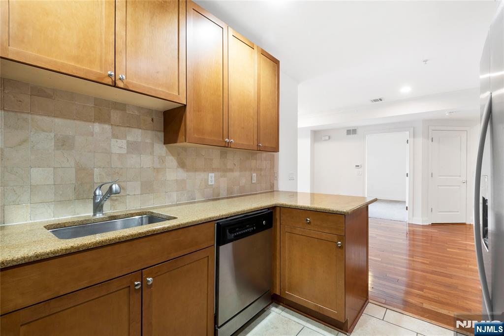 54 Polifly Road, Unit 311 Hackensack, NJ 07601 - Photo 9 of 20 a kitchen with a sink and cabinets