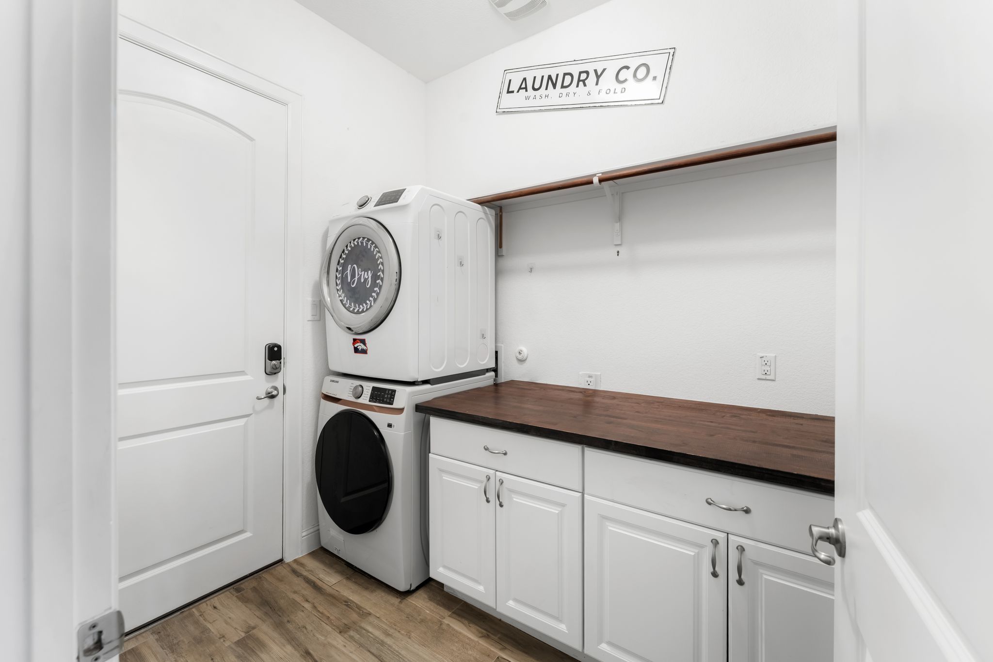 140 Waterloo Cove Georgetown, TX 78628 - Photo 30 of 40 Streamlined laundry area with a rich wooden countertop, pristine cabinetry, and convenient wall shelving.