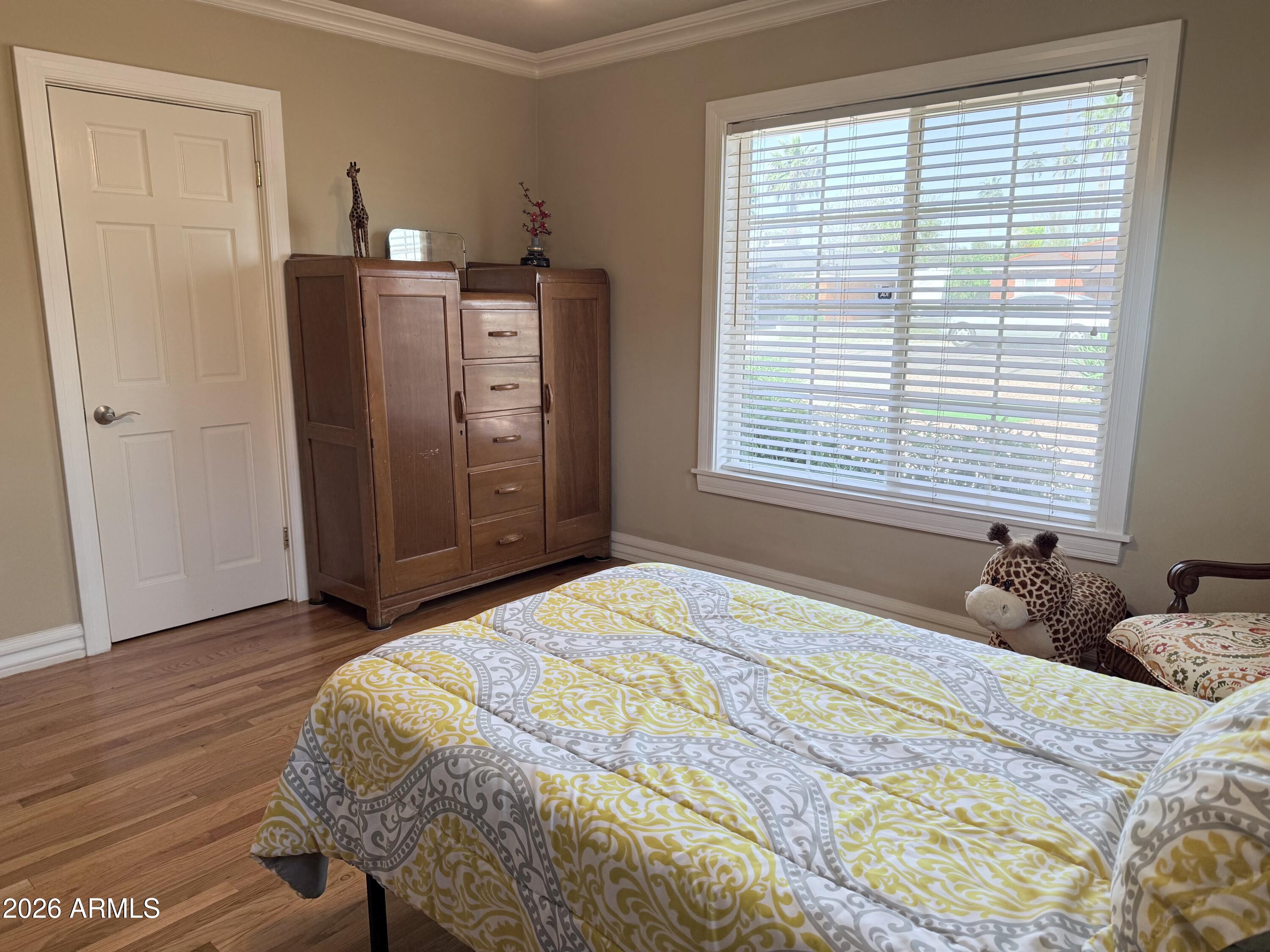 1135 East Lawrence Road Phoenix, AZ 85020 - Photo 12 of 23 a bedroom with a bed and a window