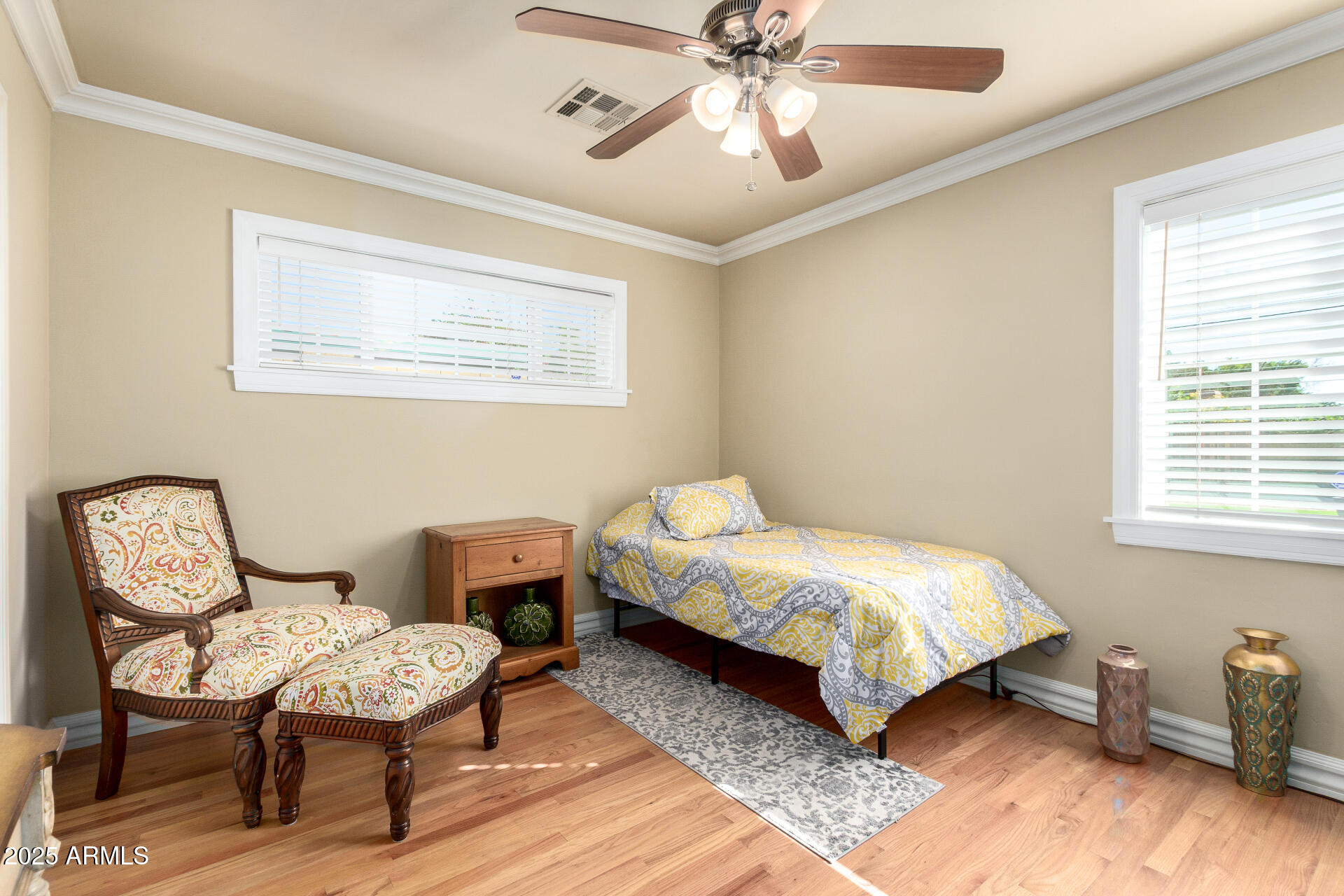 1135 East Lawrence Road Phoenix, AZ 85014 - Photo 14 of 18 a bedroom with a bed and a chandelier