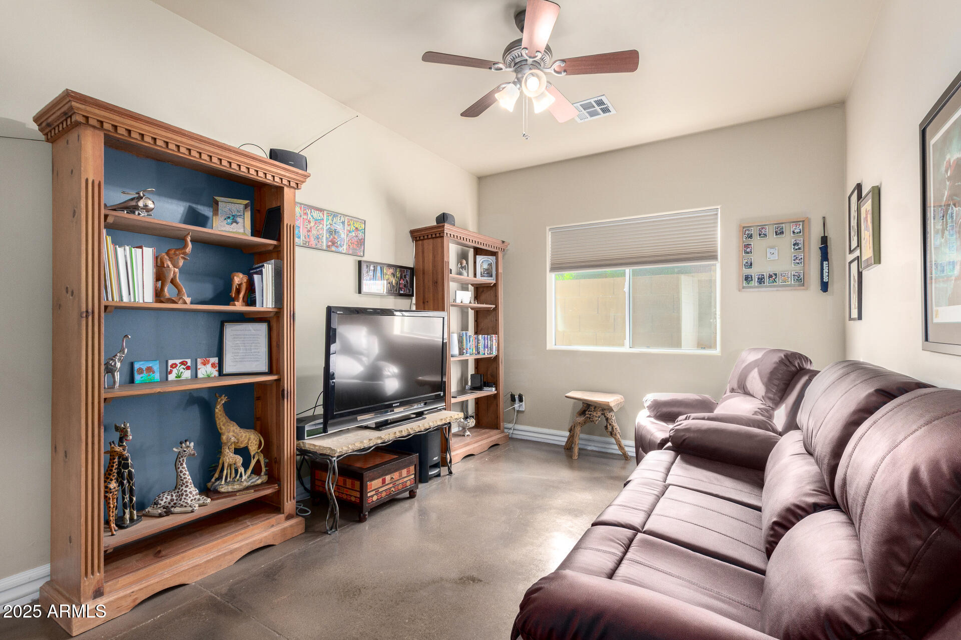 1135 East Lawrence Road Phoenix, AZ 85014 - Photo 15 of 18 a living room with furniture and a flat screen tv