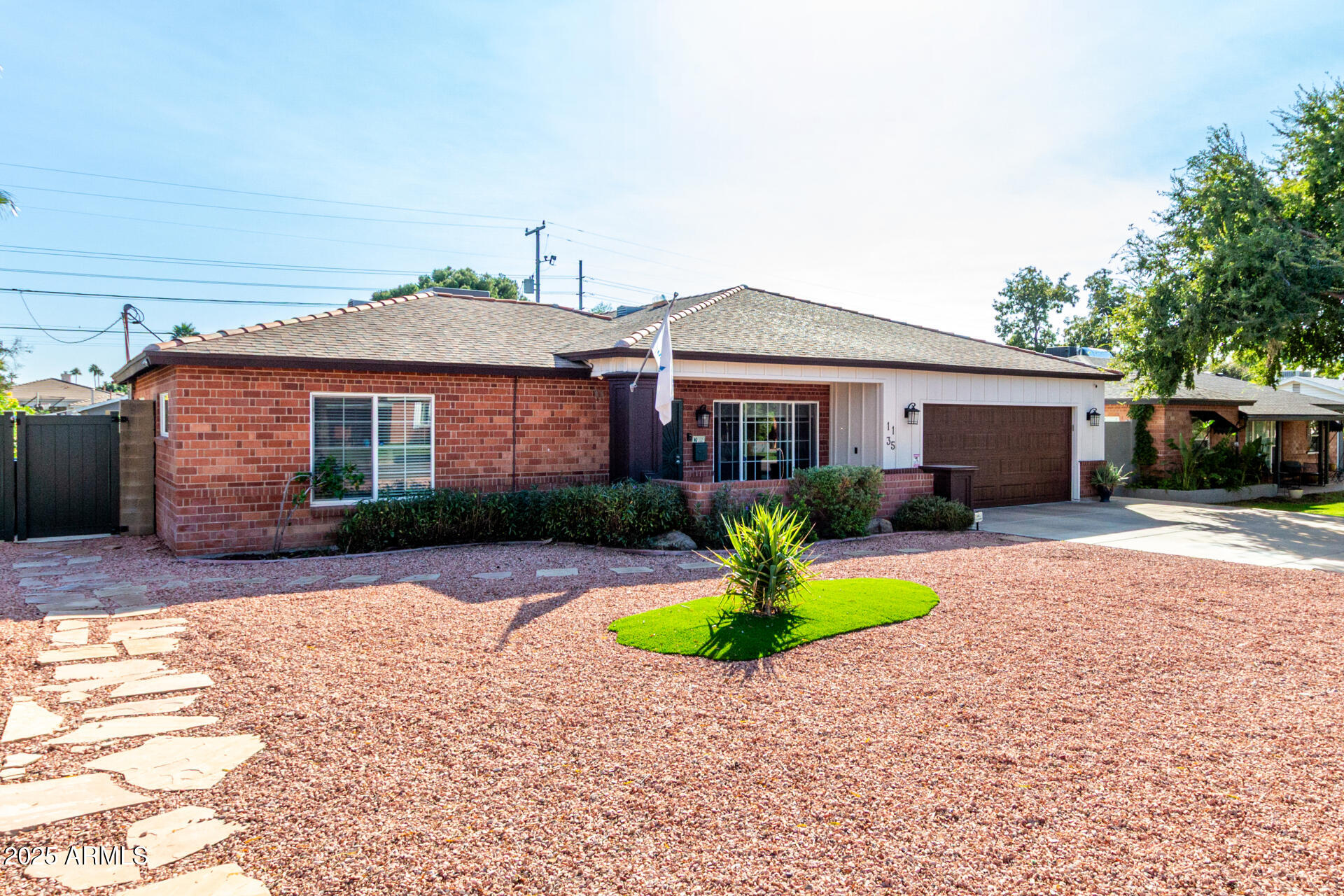 1135 East Lawrence Road Phoenix, AZ 85014 - Photo 2 of 18 a front view of a house with a garden and trees