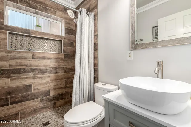 a white toilet sitting next to a bathroom sink