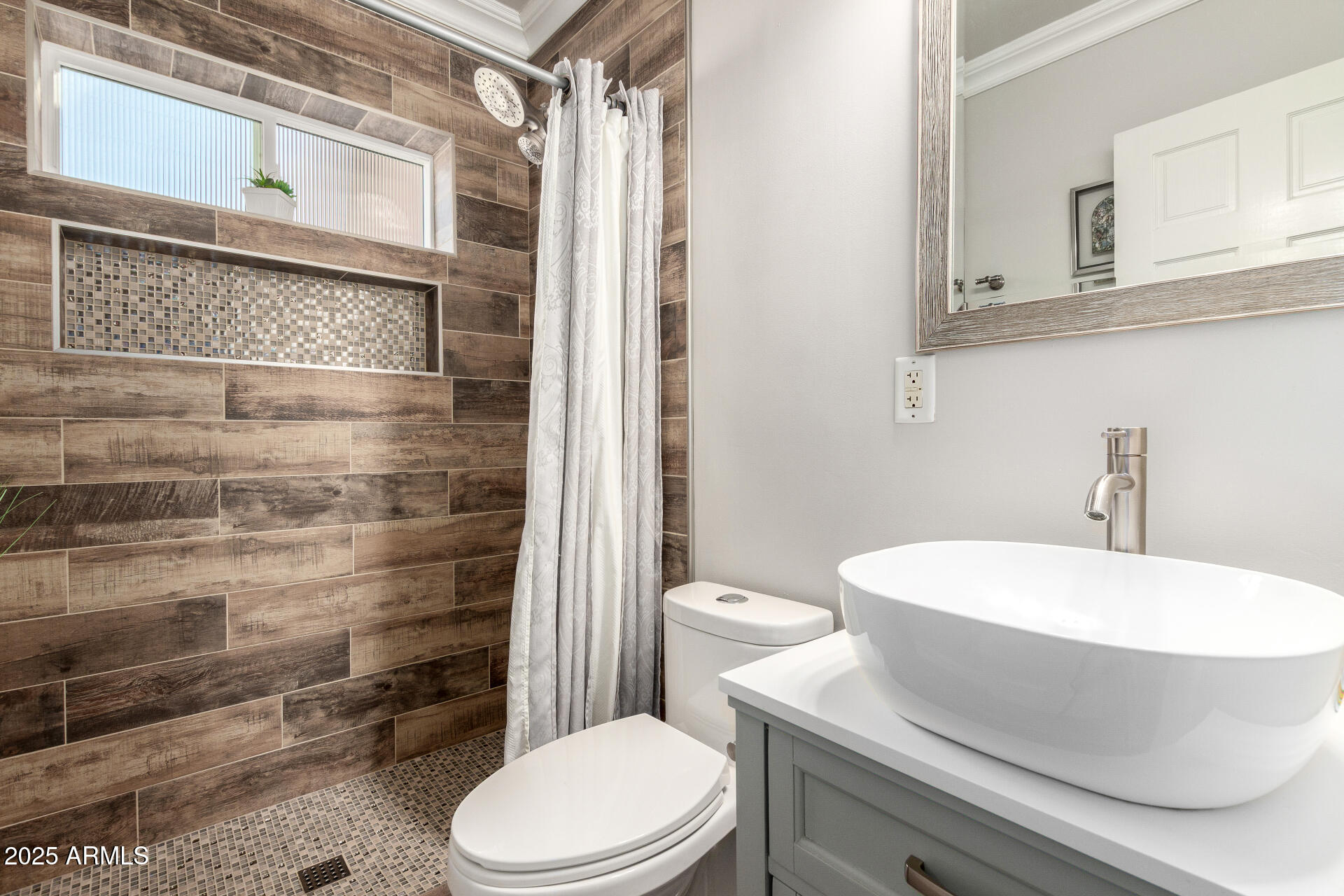 1135 East Lawrence Road Phoenix, AZ 85014 - Photo 5 of 18 a white toilet sitting next to a bathroom sink