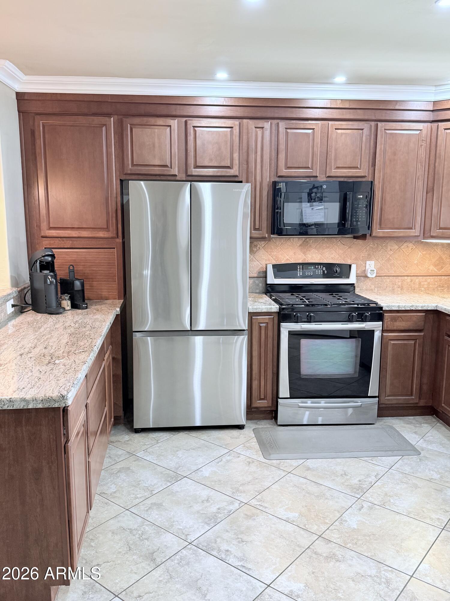 1135 East Lawrence Road Phoenix, AZ 85020 - Photo 7 of 23 a kitchen with stainless steel appliances granite countertop a stove a refrigerator and a sink