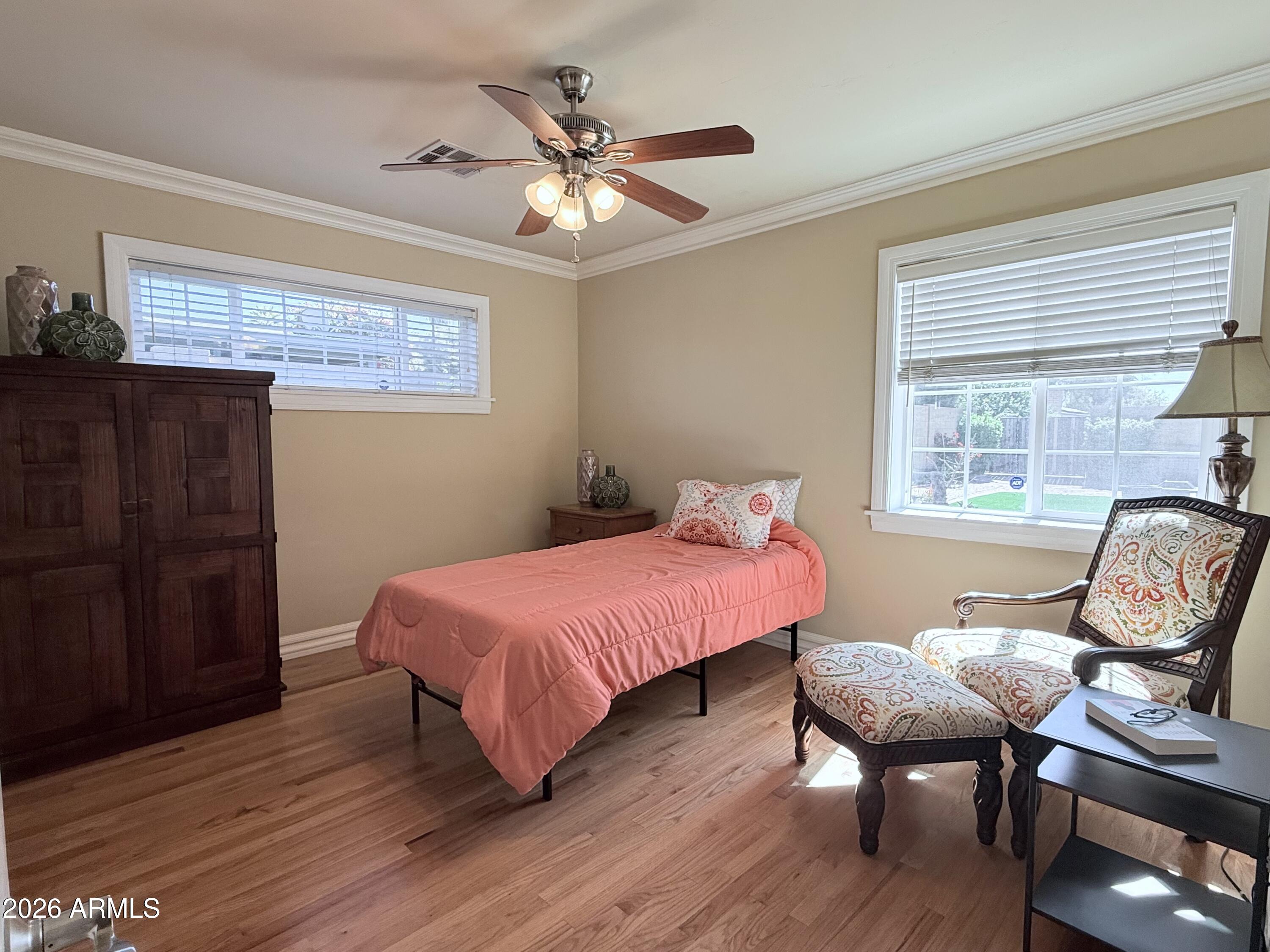 1135 East Lawrence Road Phoenix, AZ 85020 - Photo 8 of 23 a bedroom with a bed and wooden floor