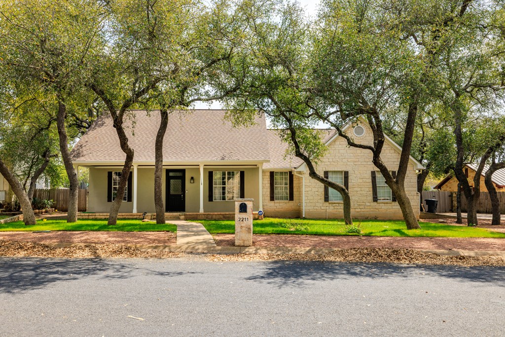 2211 Hedgestone Fredericksburg, TX 78624 - Photo 3 of 5 a front view of a house with a yard and garage