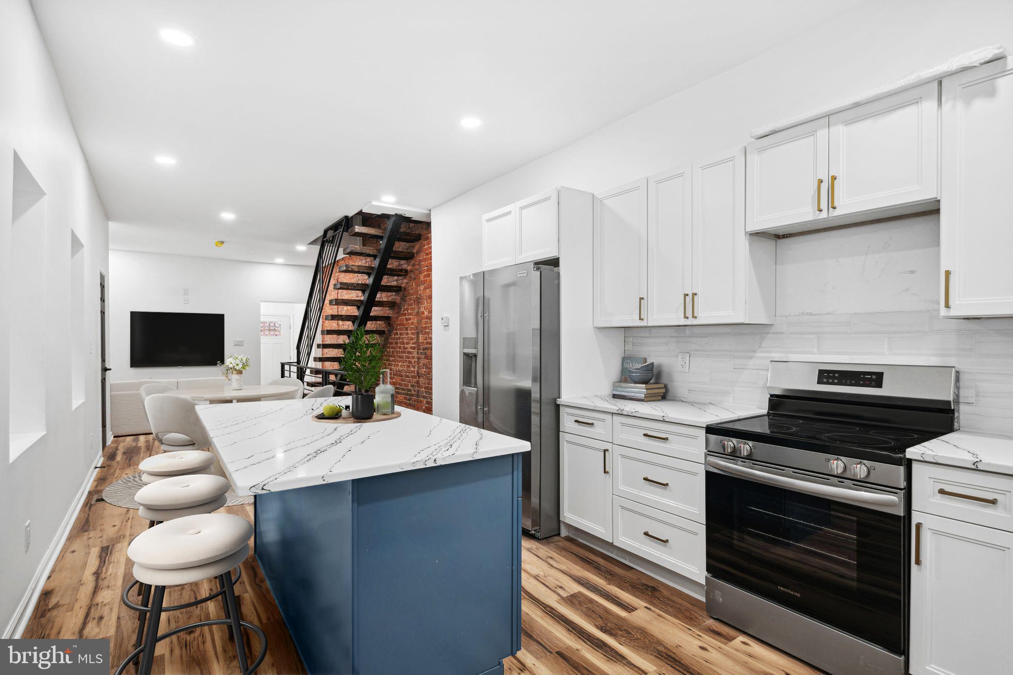 1319 North 28th Street Philadelphia, PA 19121 - Photo 1 of 9 a kitchen with a table chairs and a stove