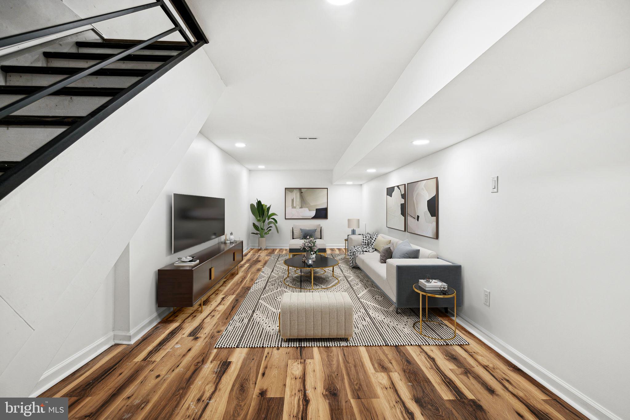 1319 North 28th Street Philadelphia, PA 19121 - Photo 6 of 9 a living room with furniture a flat screen tv and a rug